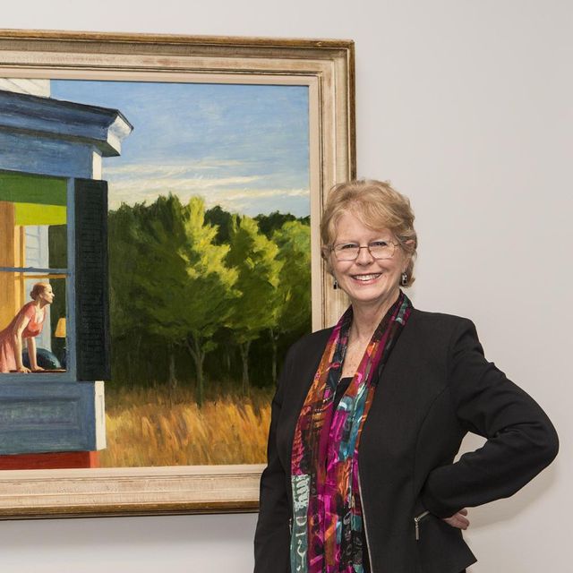 This is a photograph of Virginia Mecklenburg in front of an Edward Hopper painting.