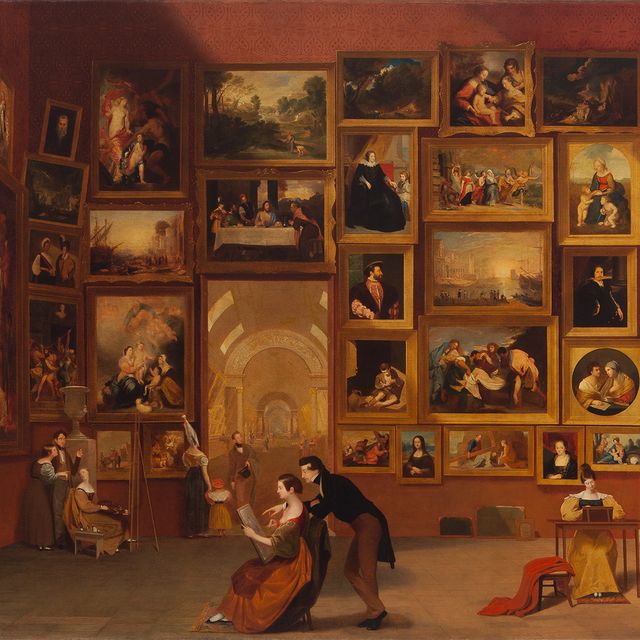 A room with many framed artworks on the walls.