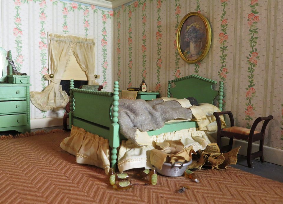 A photograph of a nutshell study of unexplained death showing a detail of a bedroom.