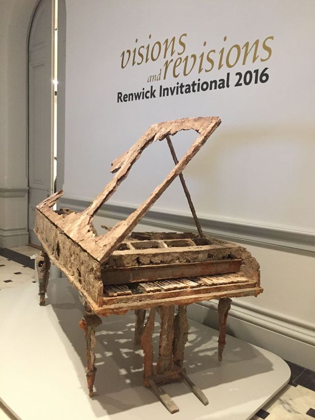 An in gallery photograph of a piano made from unfired clay.