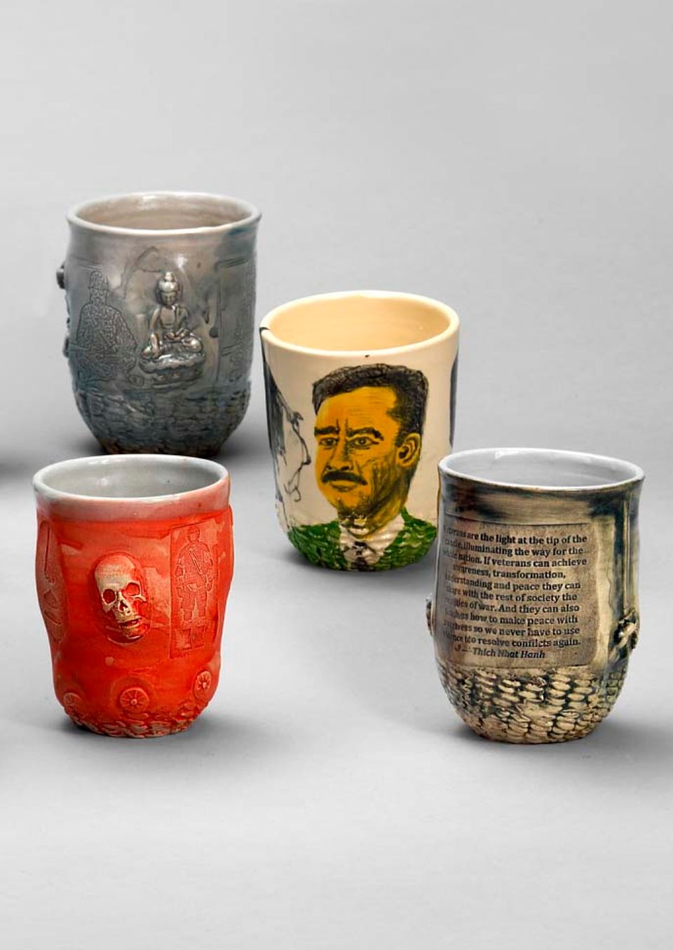 A photograph of four ceramic mugs. 