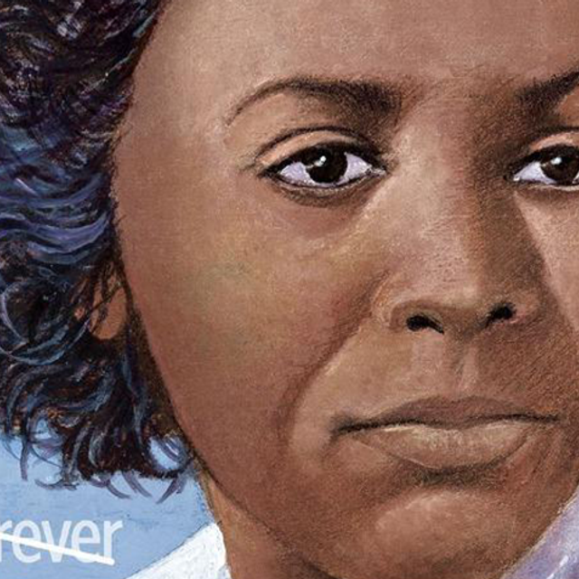 A close up of a woman of color's face on a stamp.