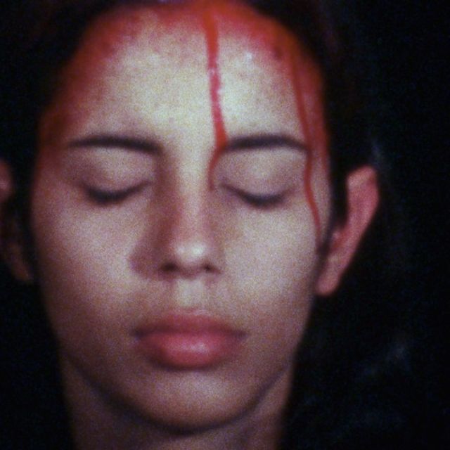 Portrait of a woman with blood dripping form her head. 