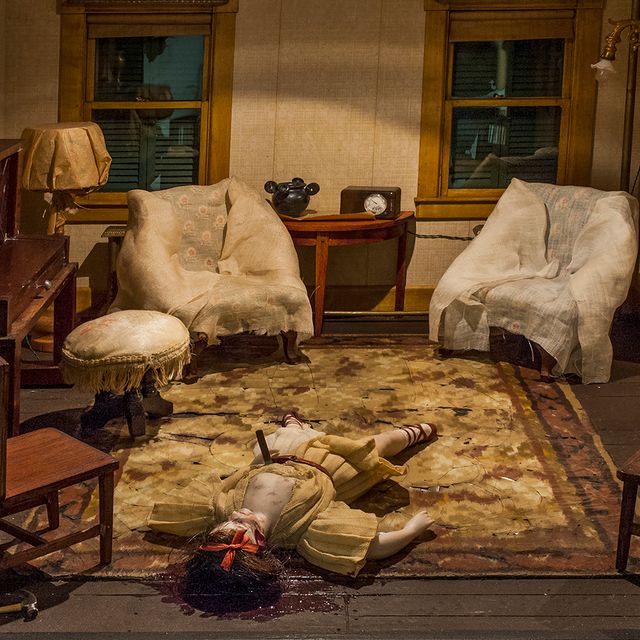 A photograph of a nutshell study of unexplained death showing a woman's death inside a parlor.