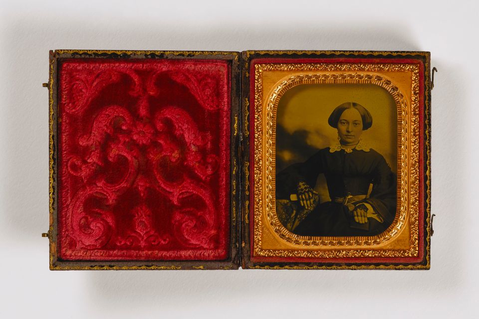 Photo of woman in a red satin frame box 