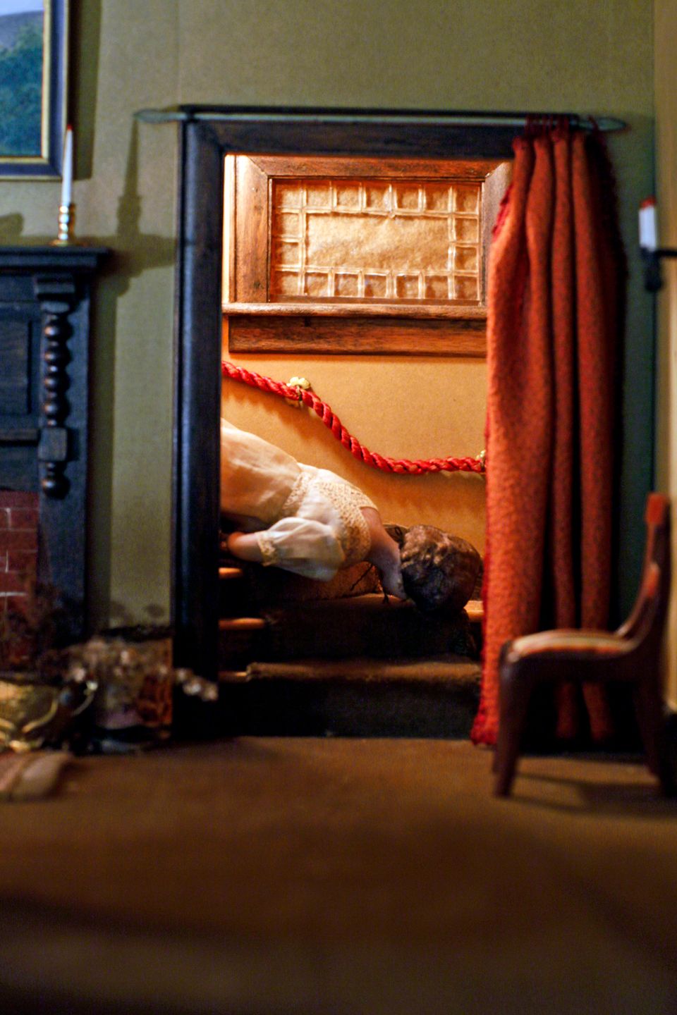 A photograph of a nutshell study of unexplained death showing a detail of a living room.