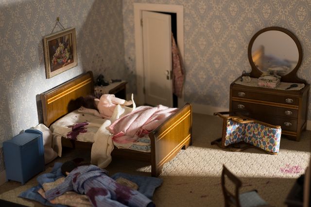 A photograph of a nutshell study of unexplained death showing a detail of a murder scene in a bedroom.