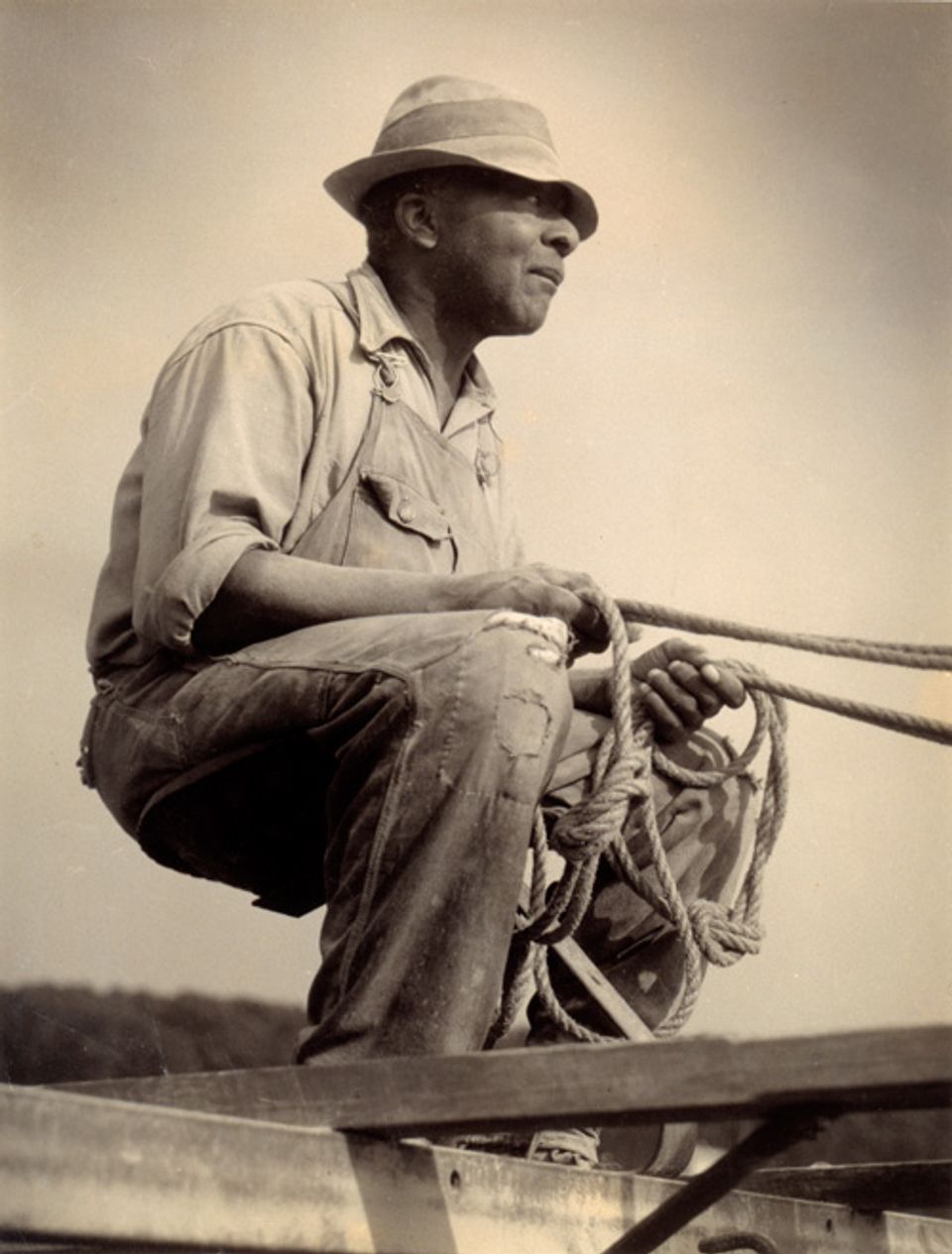 McNeill's gelatin silver print of  man sitting with reins in his hand.