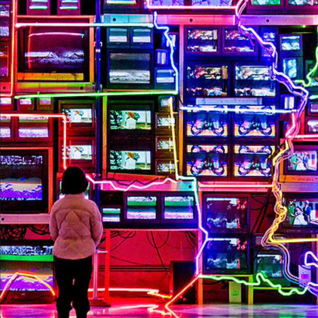 A visitor to American Art looks at Nam June Paik's Electronic Superhighway: Continental U.S., Alaska, Hawaii.