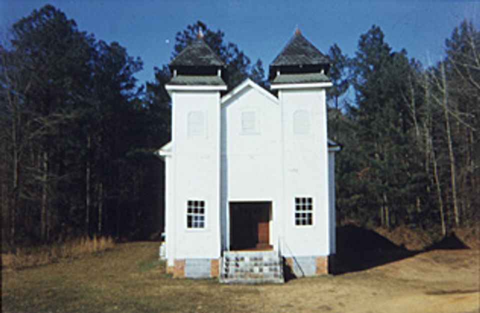 A painting of a white church in the woods