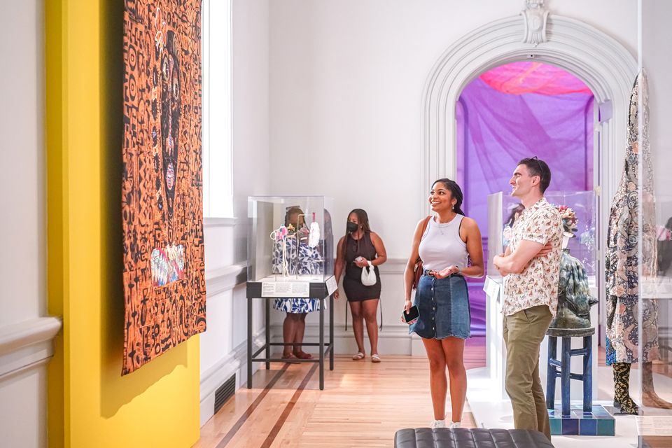 A couple stares at an intricate artwork in the Renwick Gallery