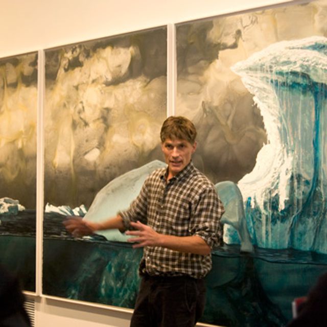 Alexis Rockman speaking in front of his painting South