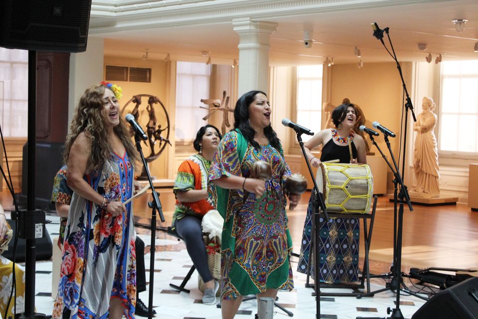 The six female musicians of La Marvela perform in the Luce Foundation Center wearing colorful clothing.
