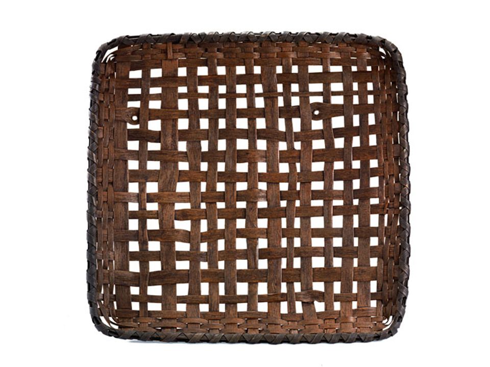 A basket that is square with a loose weave allowing for openings.