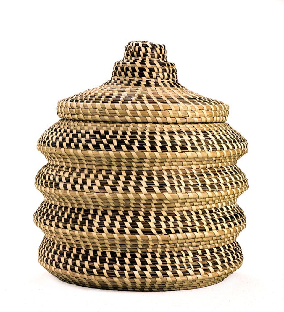 A basket with four undulating sides and a lid.
