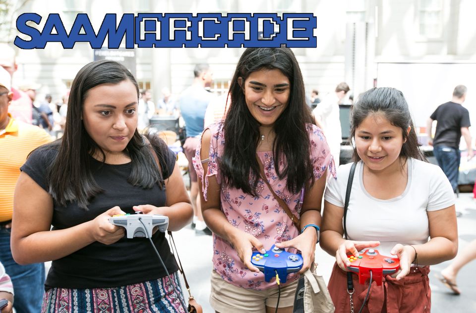 This is an image of three girls playing a video game at SAAM Arcade