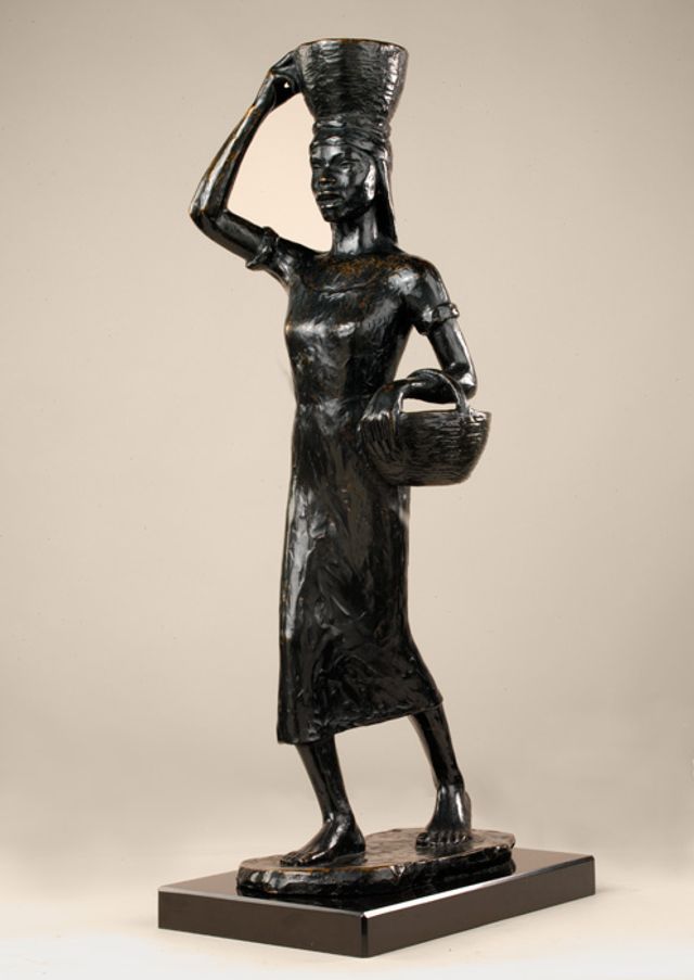 Barthe's bronze sculpture of a woman carrying a basket on her head and under her arm.