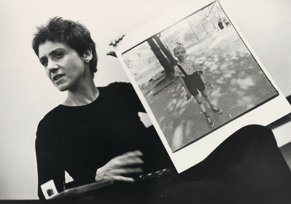 photo of Diane Arbus holding one of her photos.