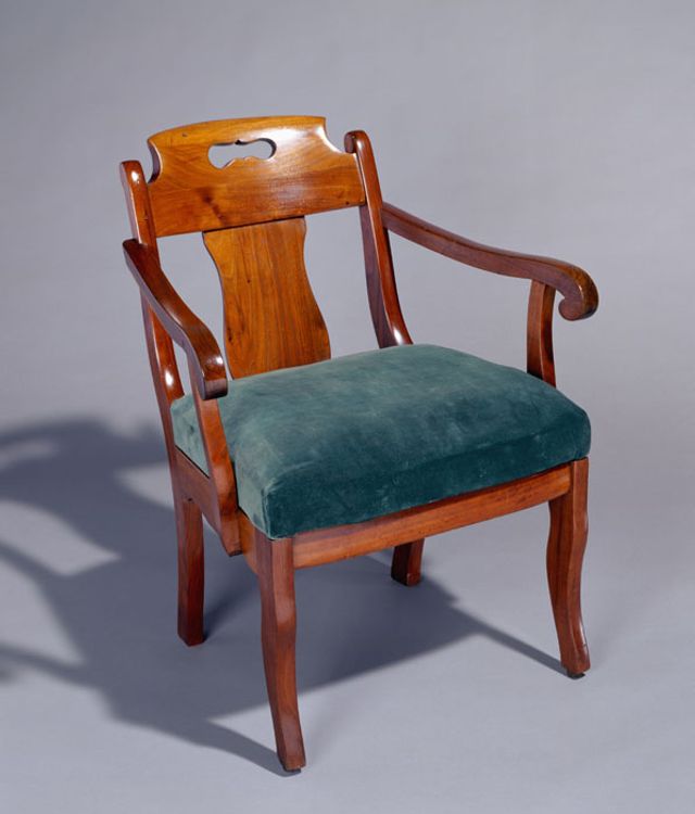 A walnut Grecian style armchair.