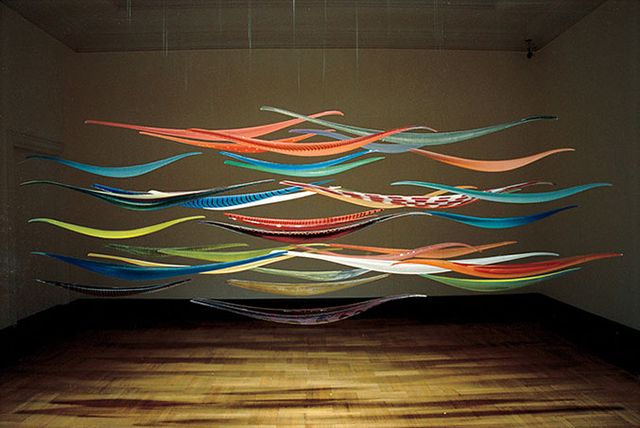 An installation shot of multiple handing glass objects.