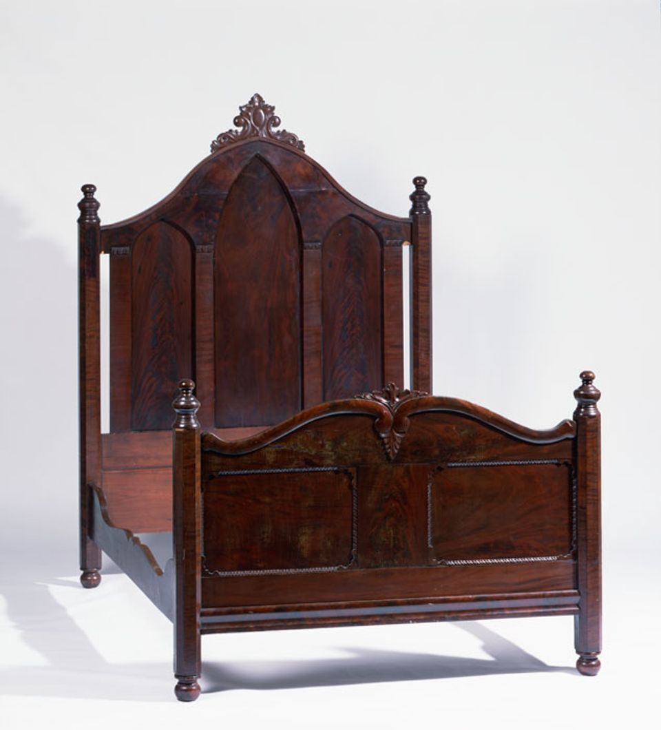 A mahogany veneer gothic bed frame with Rococo elements.