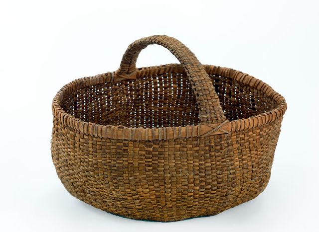 A basket that has circular shape with a handle. 