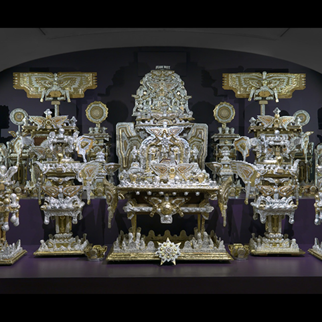 A large-scale throne made of found objects.