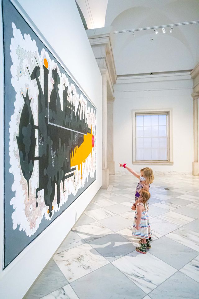 Two small girls look upon a massive painting on the third floor of the Smithsonian American Art Museum