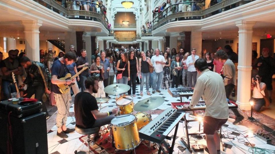 Musicians preforming to a crowd of people in the Luce Foundation Center
