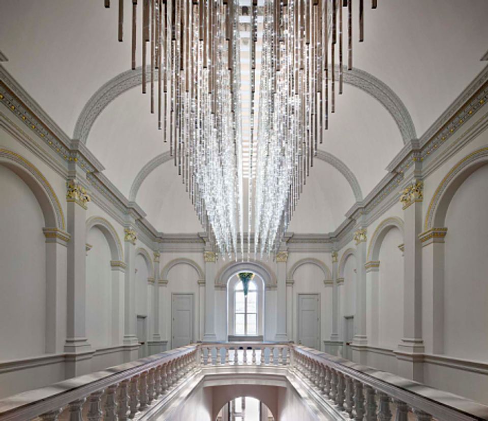 This image shows the artwork titled Volume that is portrayed at the Renwick Gallery, it's a light mirror piece that hangs over the staircase