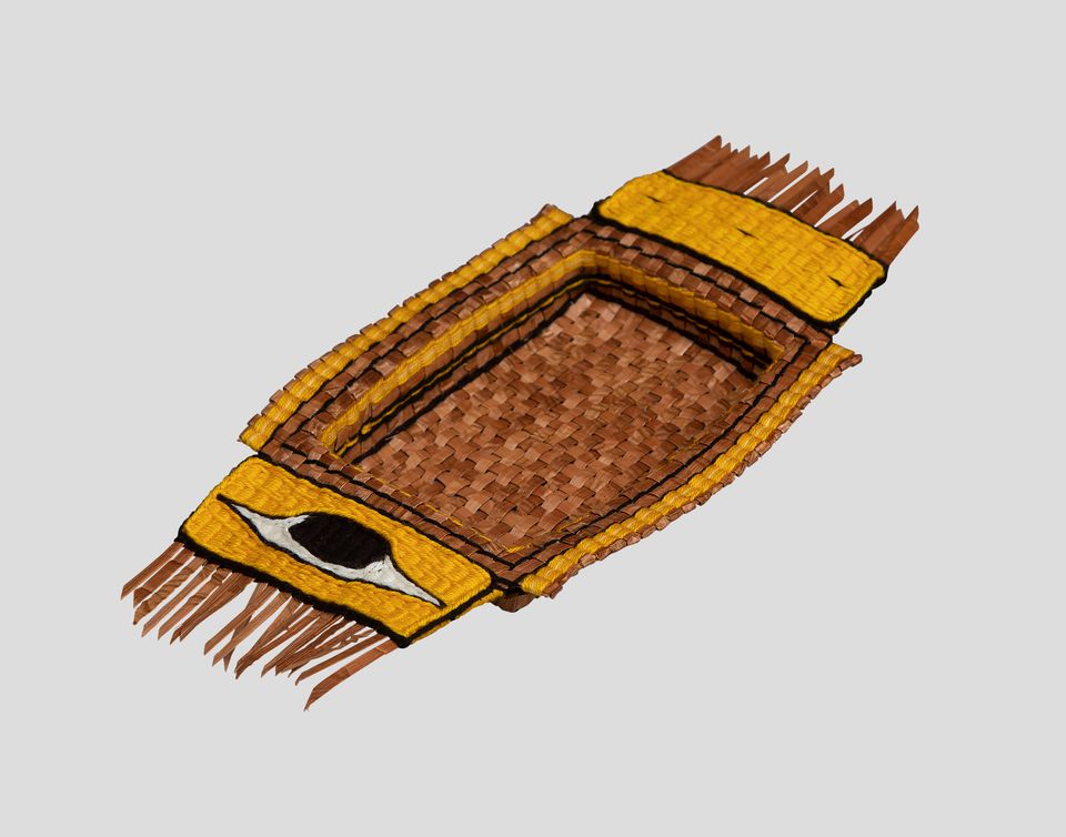 A woven, yellow, brown, and black Native American dish