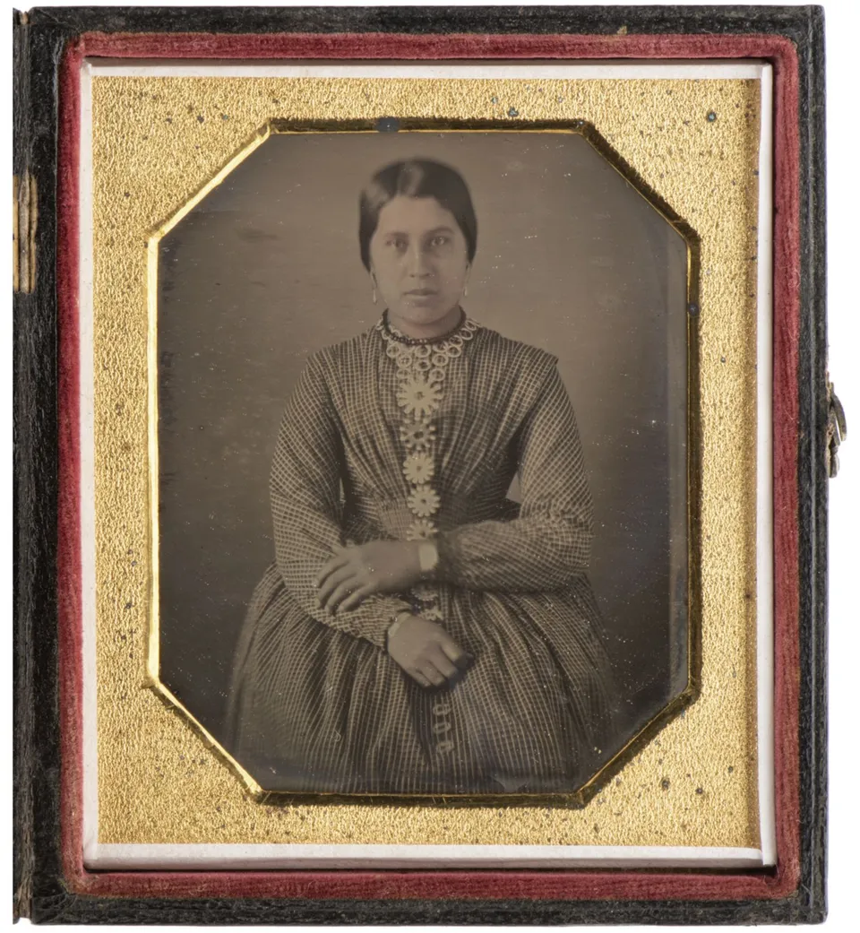 A photo of a Haudenosaunee Iroquois woman in a gold frame