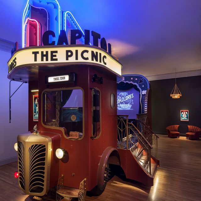 A picture of an art car that has a movie theater inside the Renwick Gallery. 