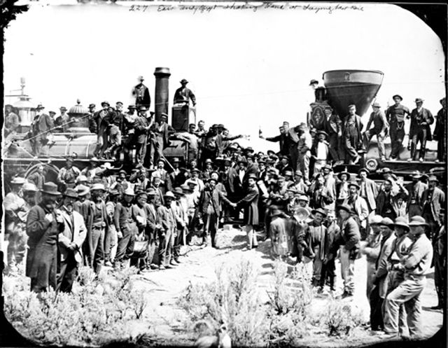 Russell's ambrotype of rail workers lined up on two sides and two shaking hands in the middle.
