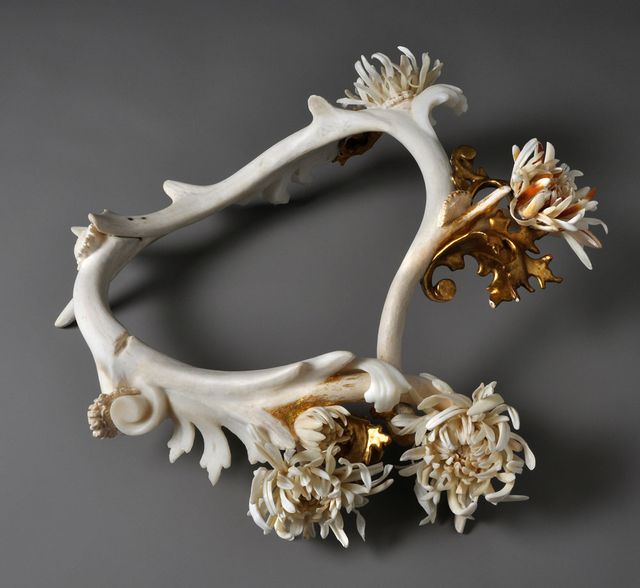 A neckpiece made of antler and bone painted gold.