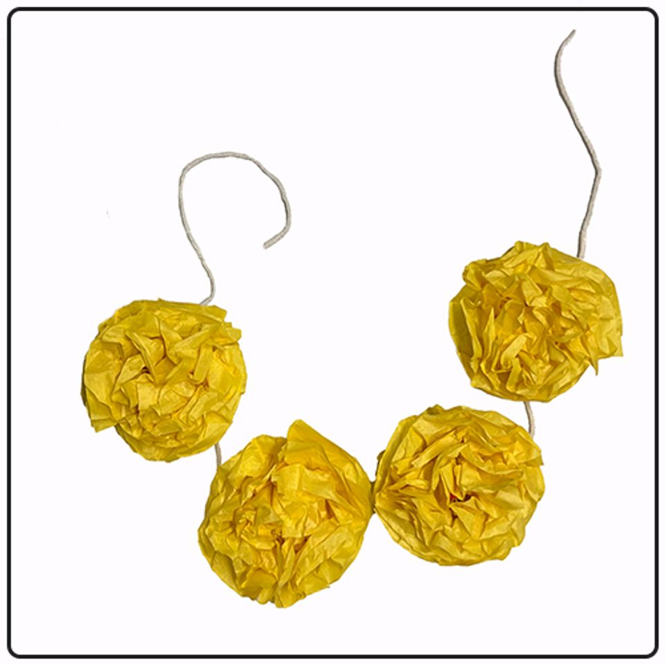 A garland made of yellow tissue paper marigolds