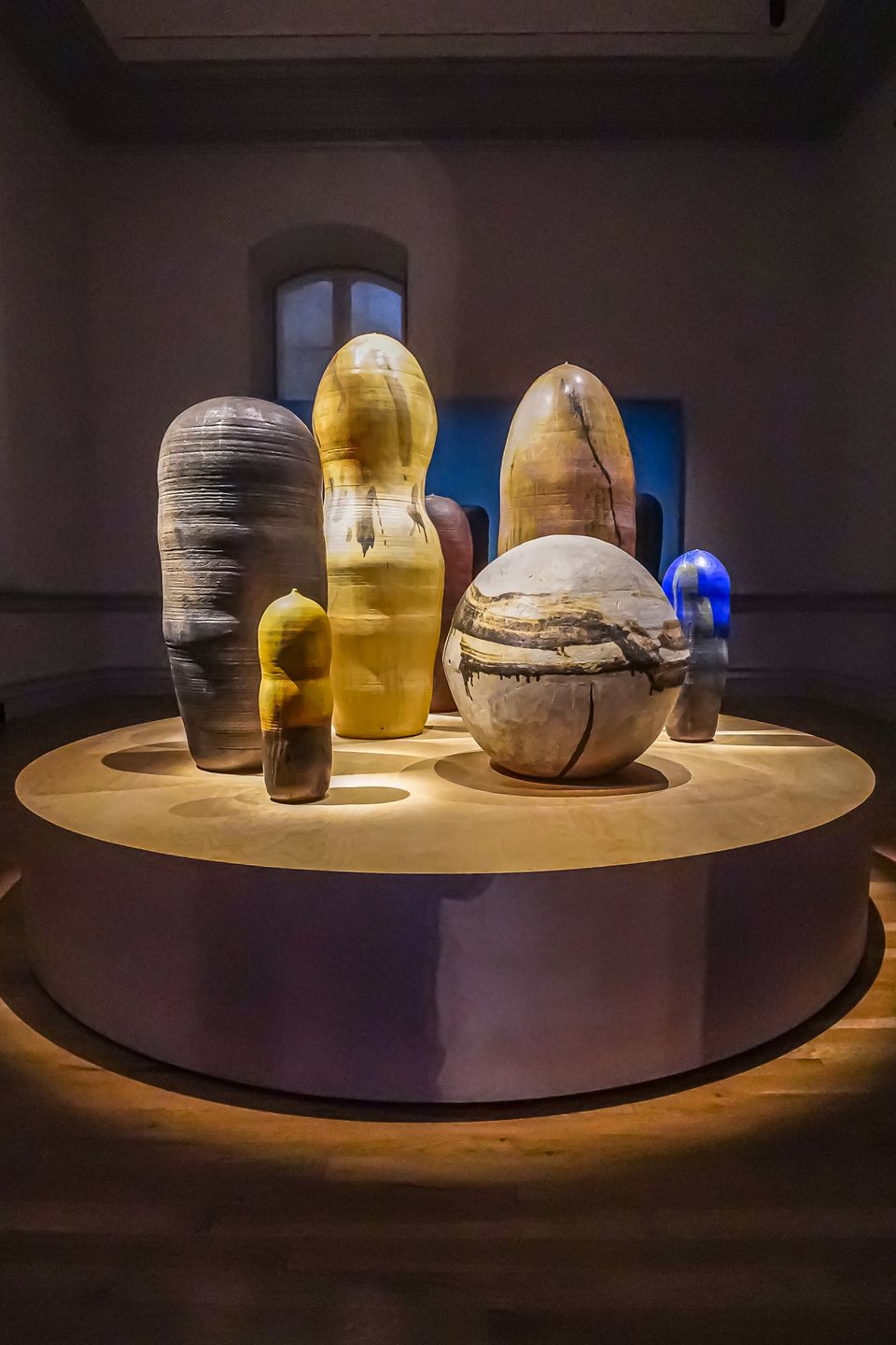 A group of ceramic sculptures on a round pedastal