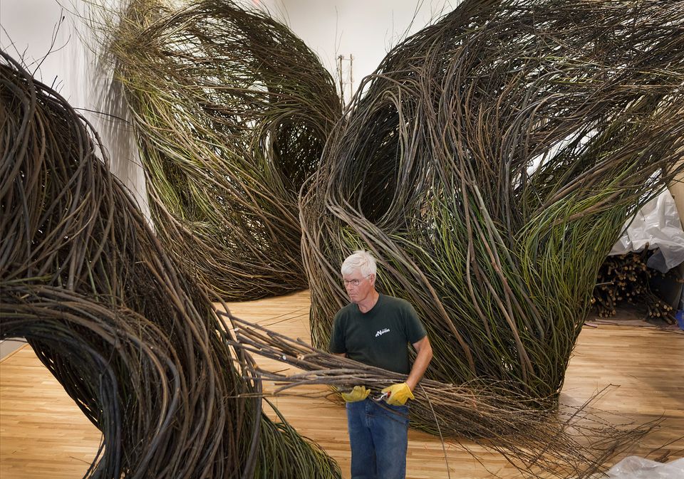 A photograph of Patrick Dougherty installing Shindig at the Renwick Gallery for WONDER.