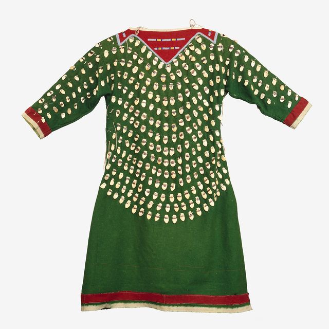 A green dress with beads and red highlights. 