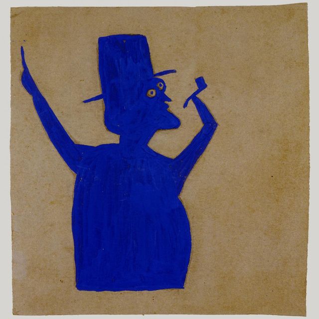 Figure of man wearing hat and holding pipe in hand with arms raised.