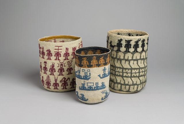 Three ornate, weaved baskets with designs.