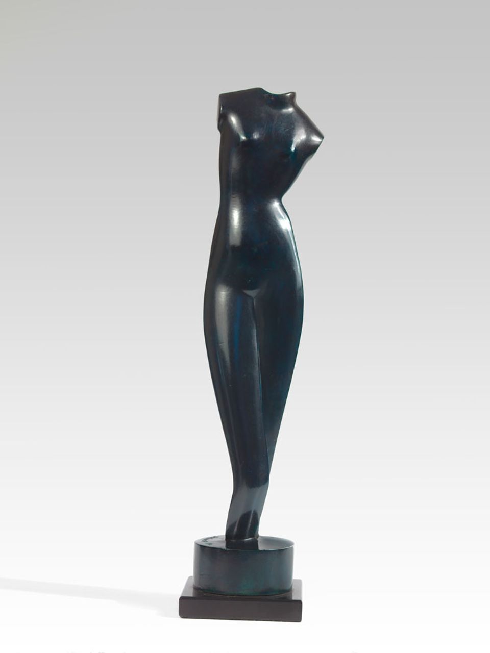 A bronze sculpture of a female figure without a head.