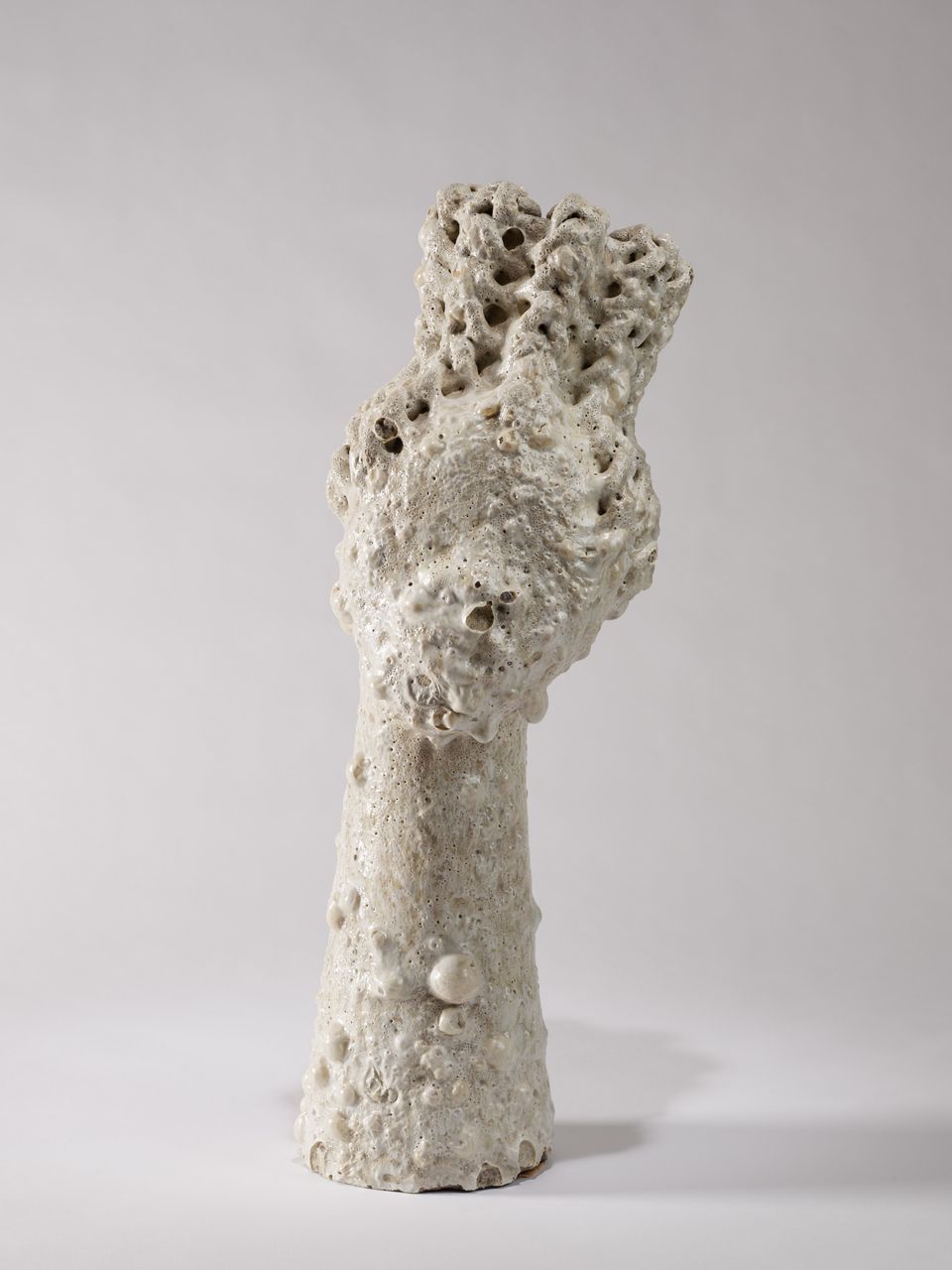 White clay figure in the form of a person with the essential parts fading away and becoming abstract and unrecognizable.