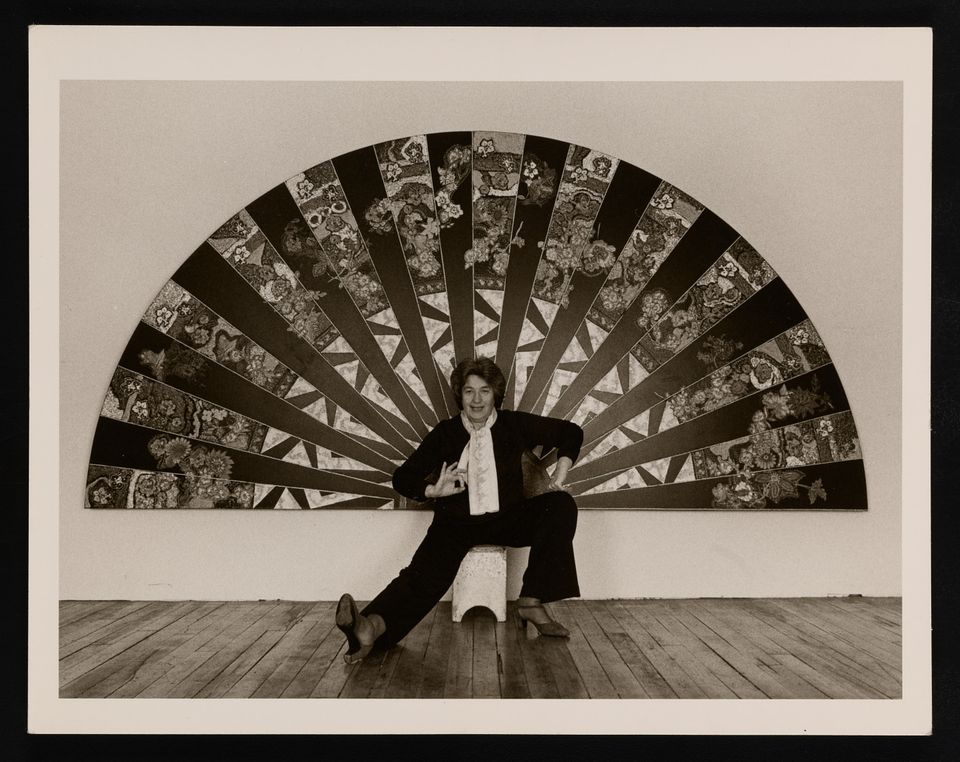 Photograph of Miriam Schapiro with her work, ca. 1981. Photo by Ellie Thompson. Miriam Schapiro scrapbooks, 1951-1981, Archives of American Art, Smithsonian Institution