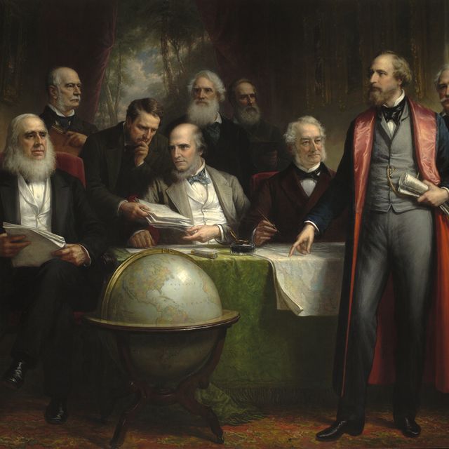 A room with men and a globe
