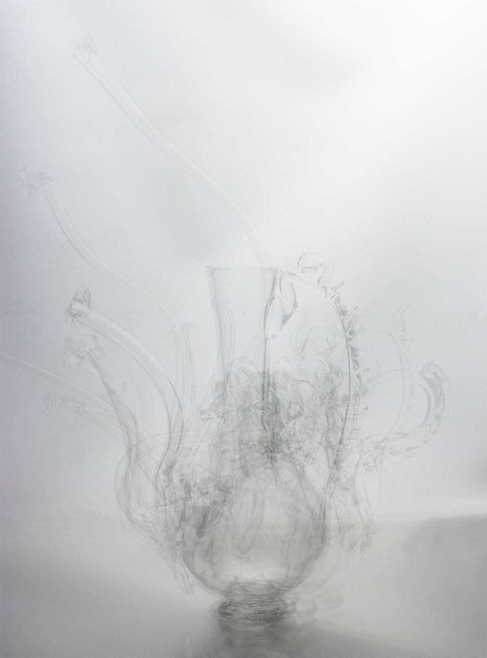 A photograph of a glass object with smoke around it. 