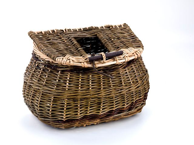 A basket with a rectangular base that transforms into a smaller circle with a lid. 