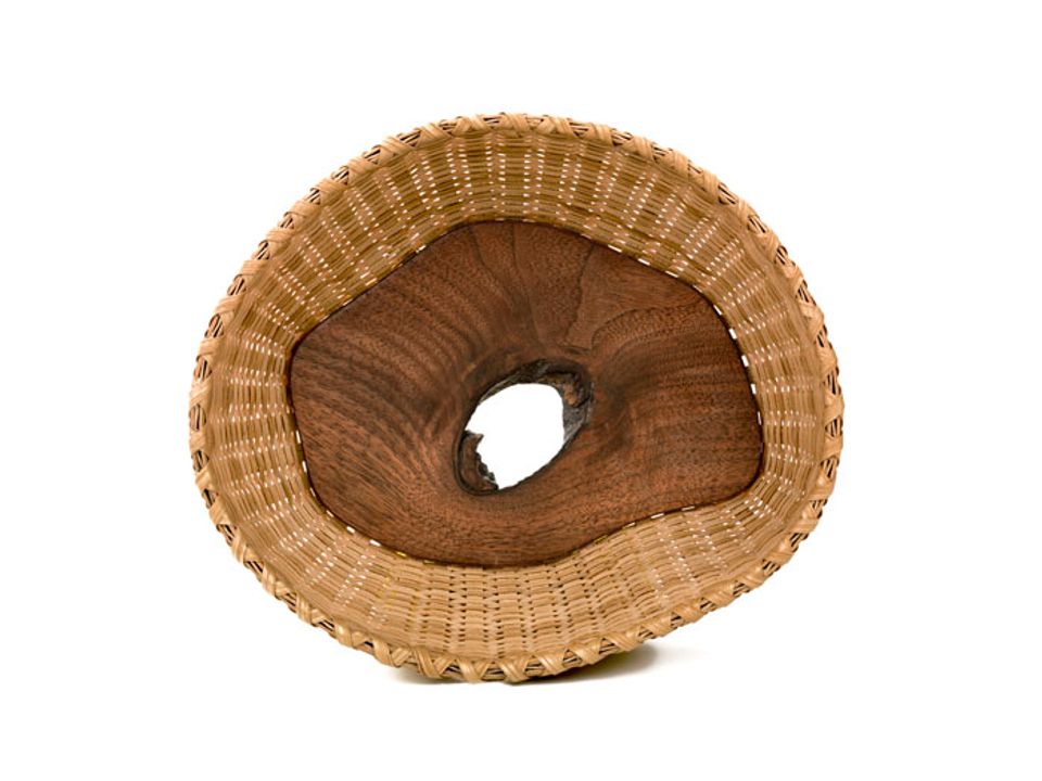 A basket with a white oak and walnut center. 