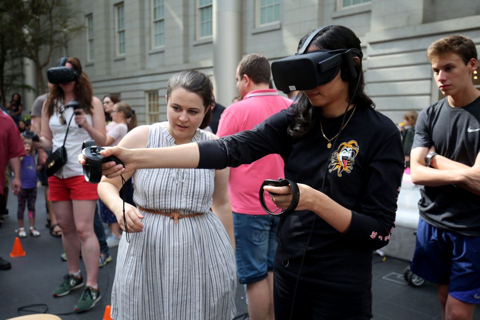 An image of a woman trying a VR (virtual reality) headset