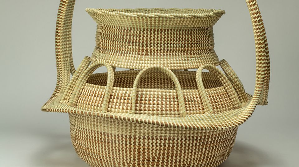 A close up detail of a coiled, sweet grass basket